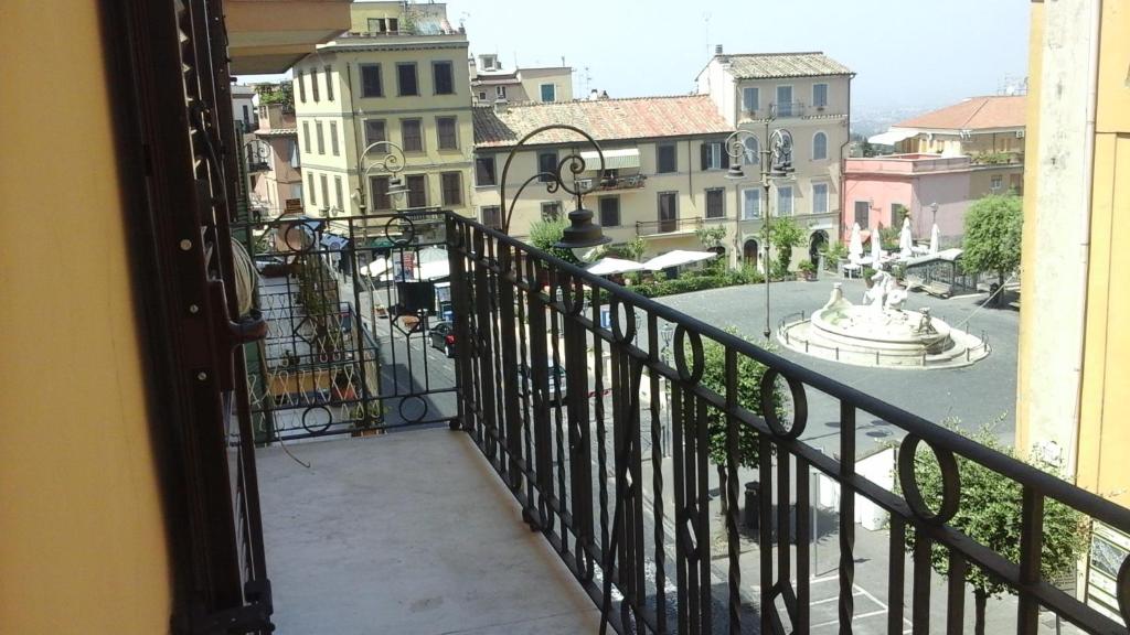 uma varanda com vista para uma fonte e edifícios em La Casa del Sire em Marino
