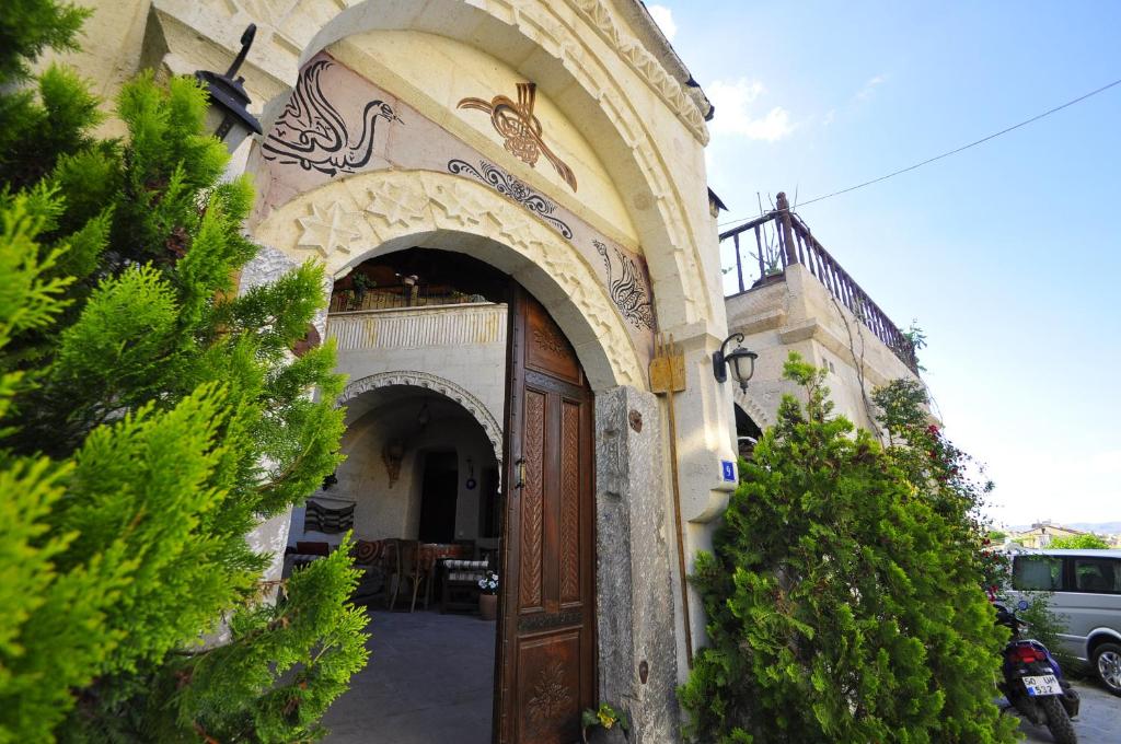 an entrance to a building with a wooden door at Kismet Cave House in Goreme