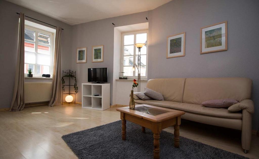 a living room with a couch and a coffee table at Haus Weihertor in Traben-Trarbach