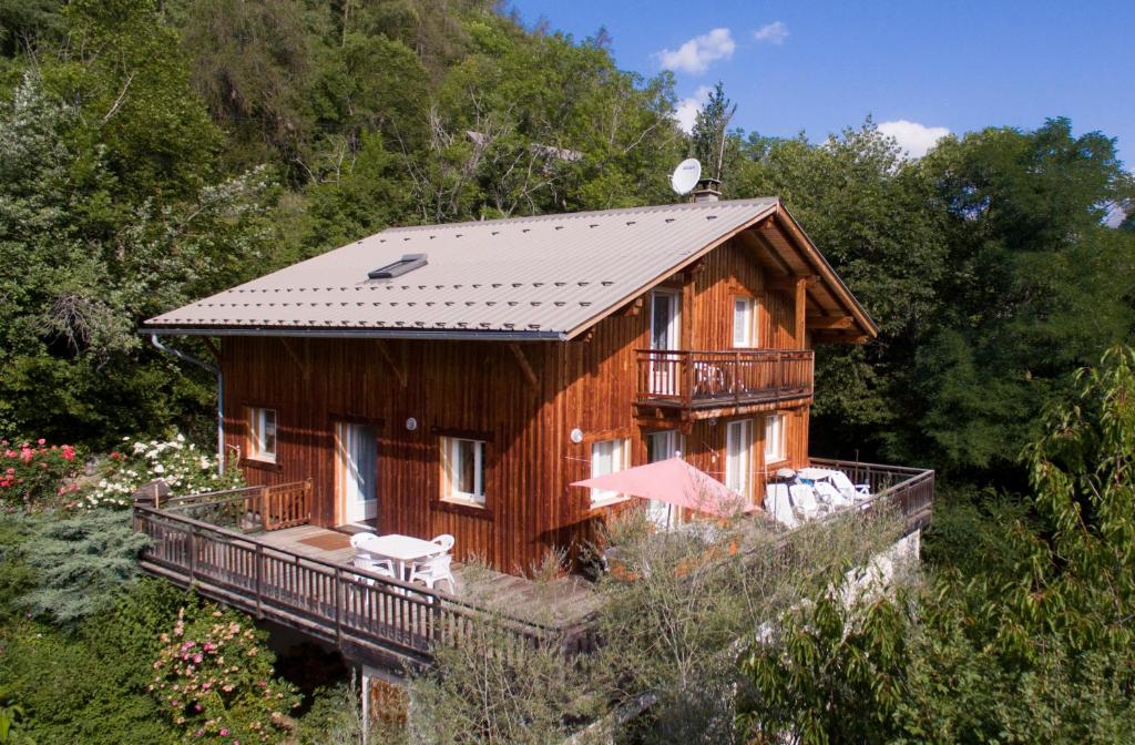 a wooden house with a balcony on a hill at La Ressource in Villars-Colmars