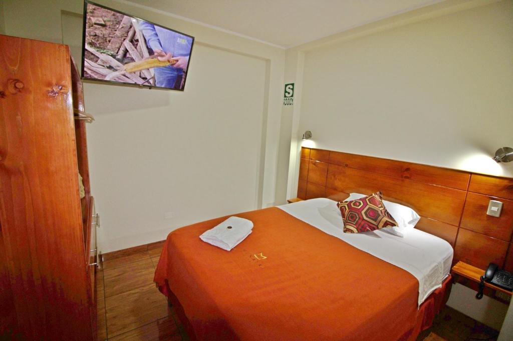 Postel nebo postele na pokoji v ubytování Munayki Hotel