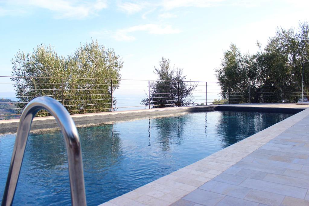 a swimming pool with a fence around it at A Baracca du Pei in Imperia