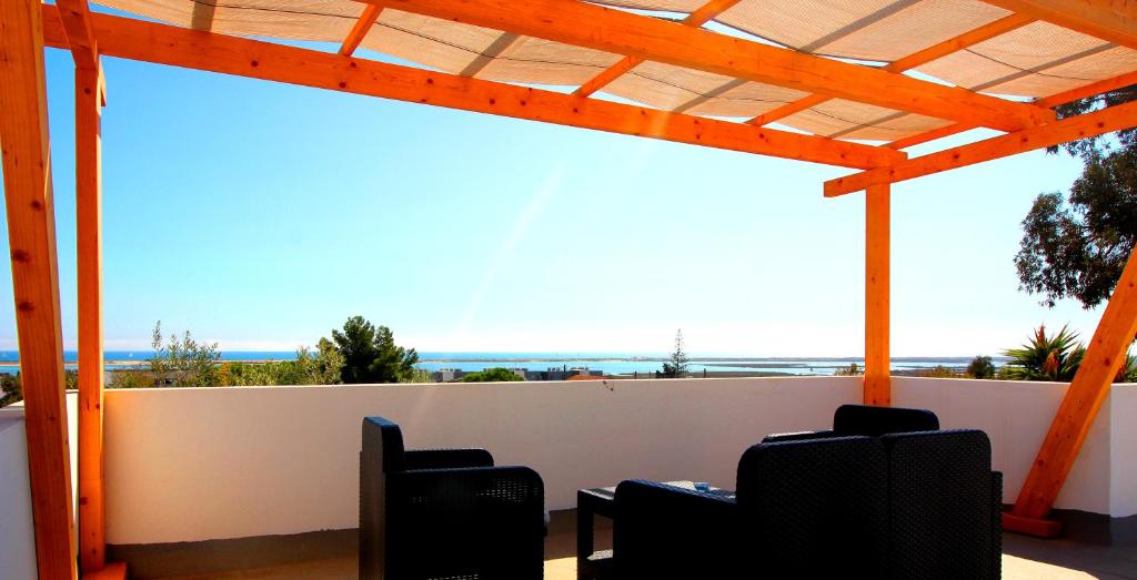 d'une terrasse avec des chaises et une vue sur l'océan. dans l'établissement White Bride FZ, à Fuzeta