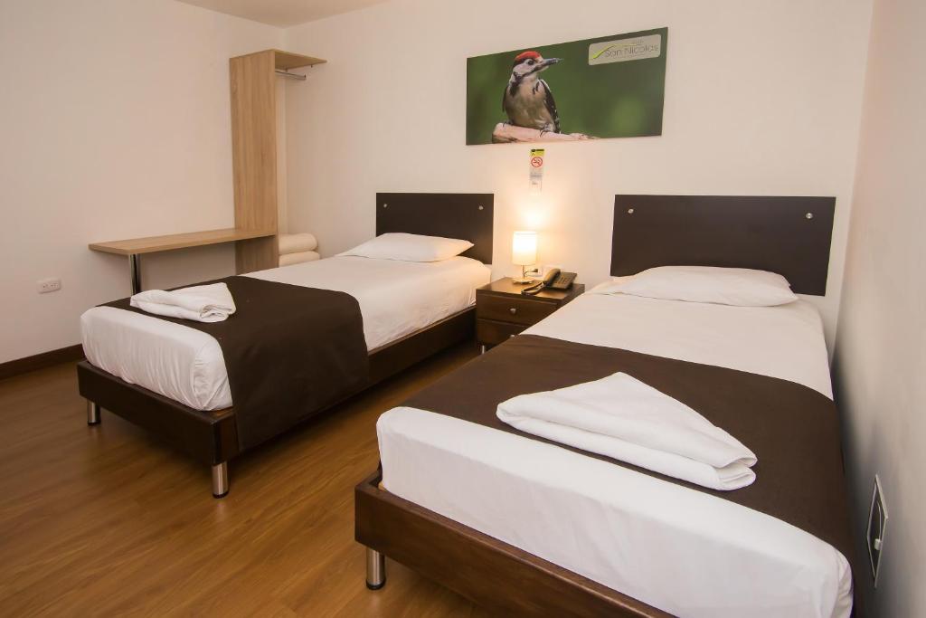 Postel nebo postele na pokoji v ubytování Hotel Valle de San Nicolas