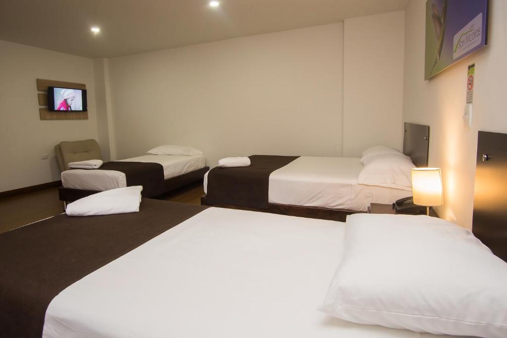 Postel nebo postele na pokoji v ubytování Hotel Valle de San Nicolas