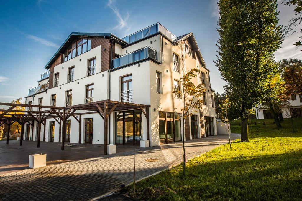 a large white building with a lot of windows at Kasor Resort & Spa in Stryków