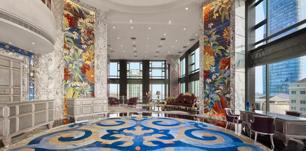 a lobby with a large room with colorful tiles at The Reverie Saigon in Ho Chi Minh City