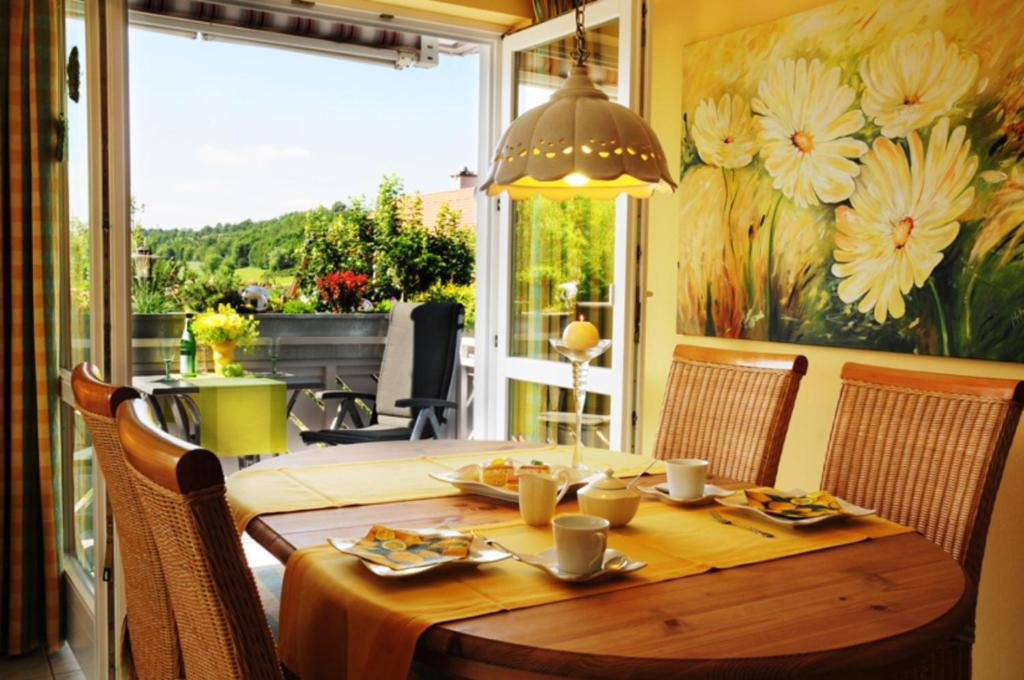 a dining room with a table and chairs and a window at Landhaus Staffelstein in Bad Staffelstein