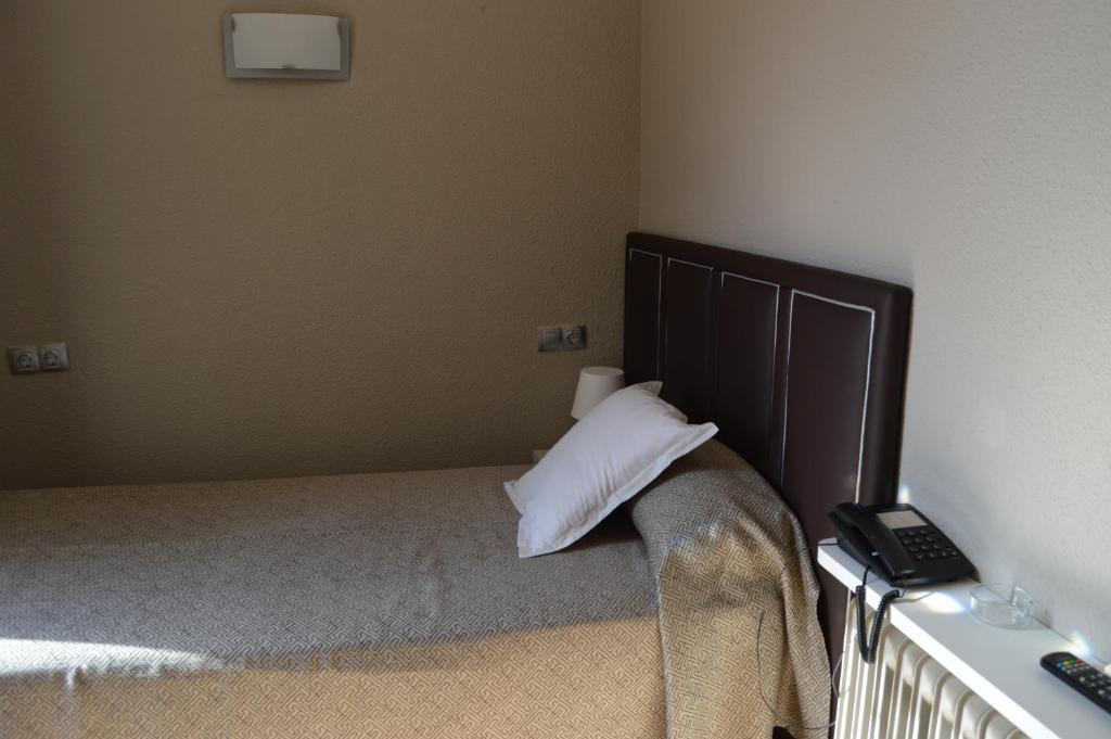 Postel nebo postele na pokoji v ubytování Hotel Ciutadella