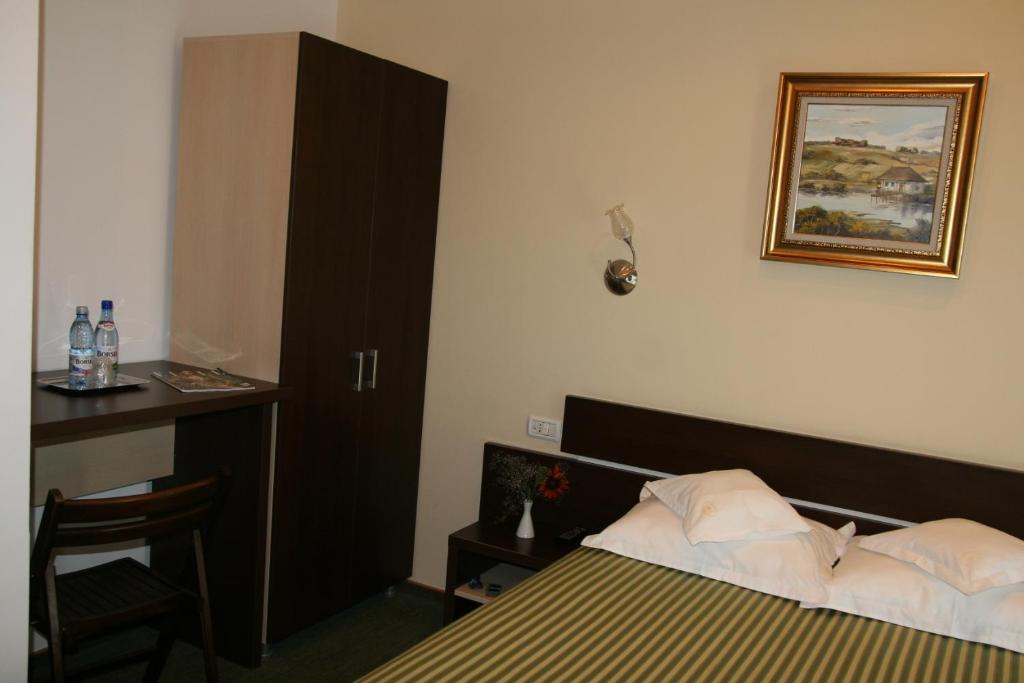 Postel nebo postele na pokoji v ubytování Hotel Kilometrul Zero