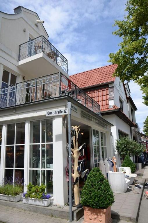 a store with a balcony on top of a building at Ferienresidenz Am Strom in Warnemünde