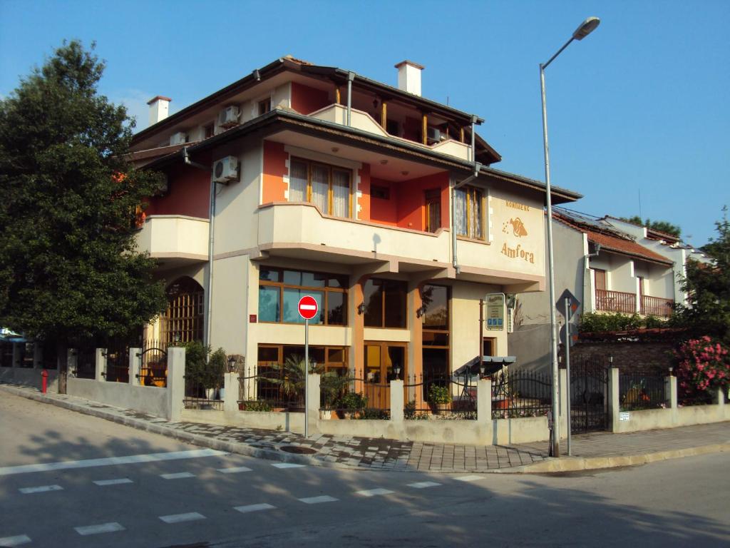 a large building on the corner of a street at Amfora Guest House in Byala