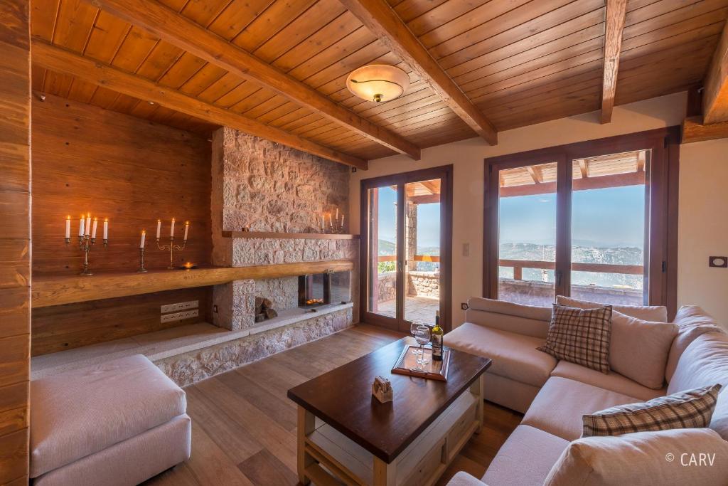 a living room with a couch and a table at Kallisto Mountain House I in Arachova