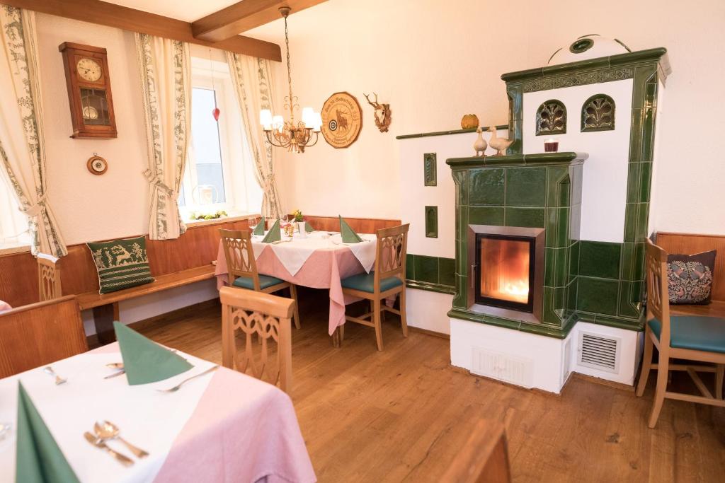 a restaurant with a fireplace and a table and chairs at Schlossgasthof in Artstetten