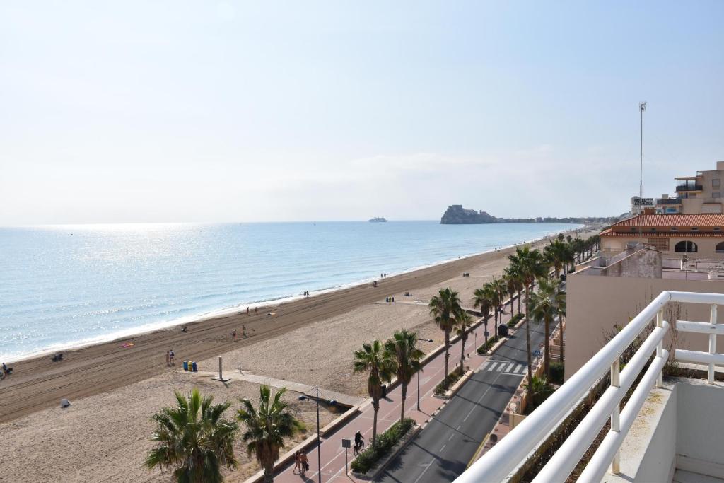 a view of the beach from the balcony of a building at Atico Peniscola in Peniscola