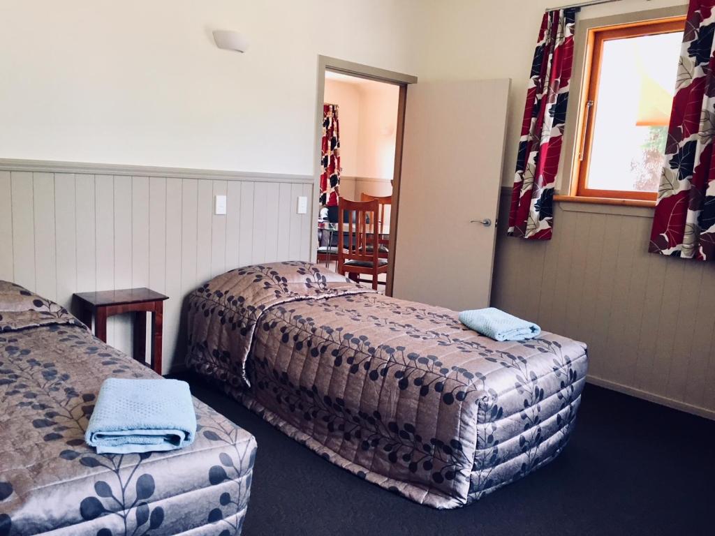 Postel nebo postele na pokoji v ubytování NASEBY lodge