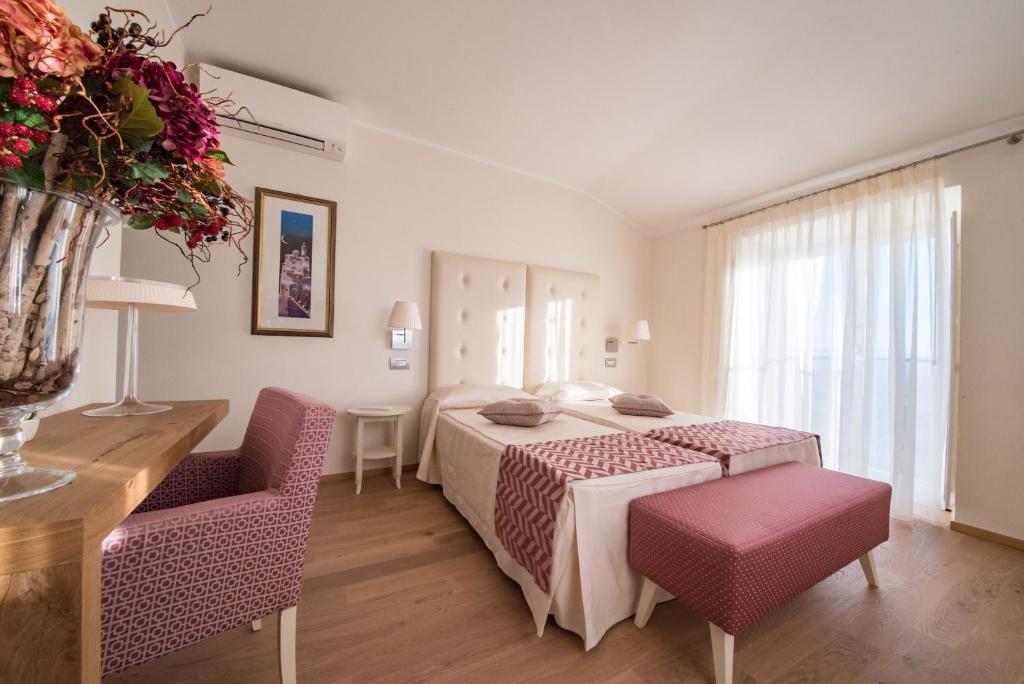 Postel nebo postele na pokoji v ubytování Hotel Il Palazzo
