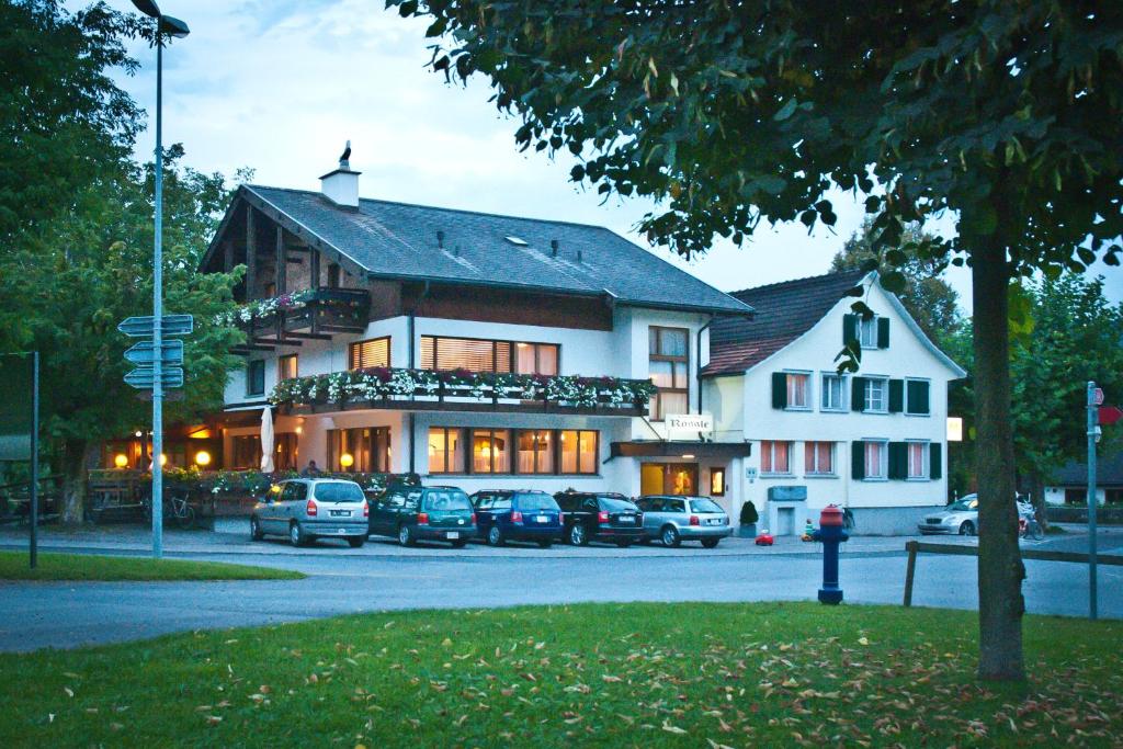 a large building with cars parked in front of it at Landgasthof Rössle ** Superior in Ruggell