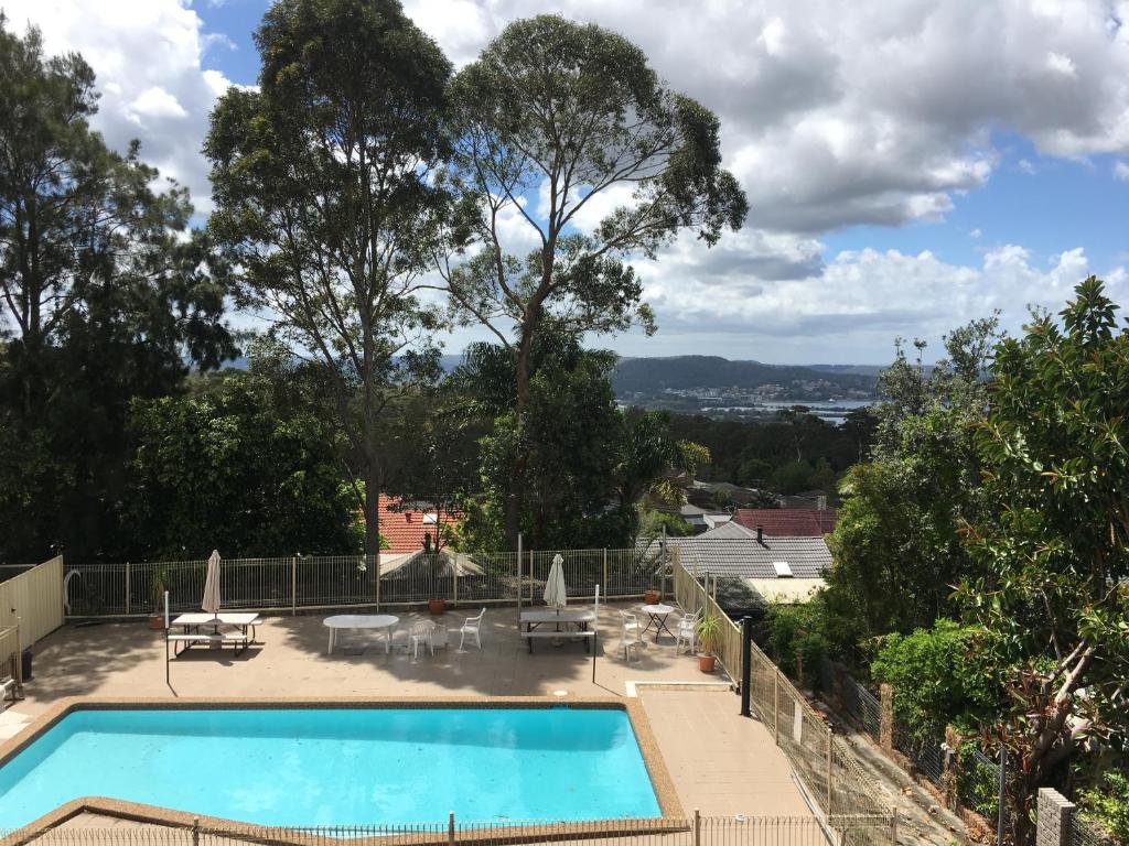 a swimming pool with a view of the city at Bella Vista Motel in Gosford