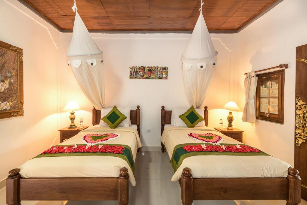 Postel nebo postele na pokoji v ubytování Hotel Bunga Permai