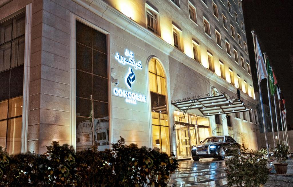 a large building with a clock on the front of it at Concorde Hotel Doha in Doha