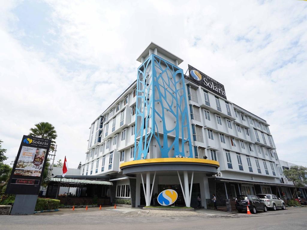 a large hotel with a blue building at Solaris Hotel Malang in Malang