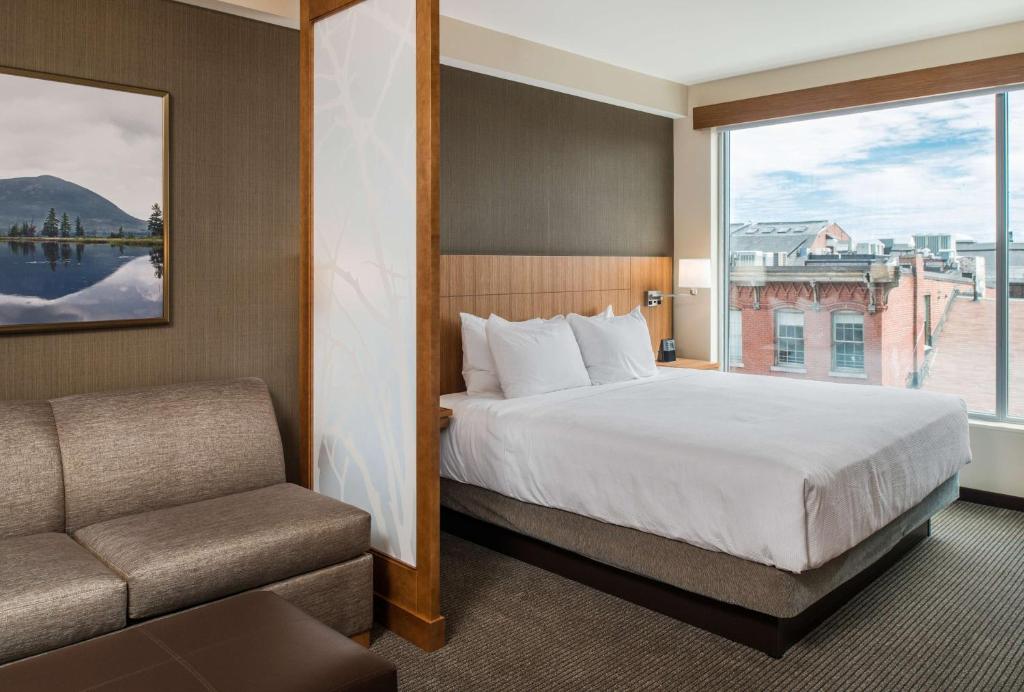 a hotel room with a bed and a window at Hyatt Place Portland-Old Port in Portland