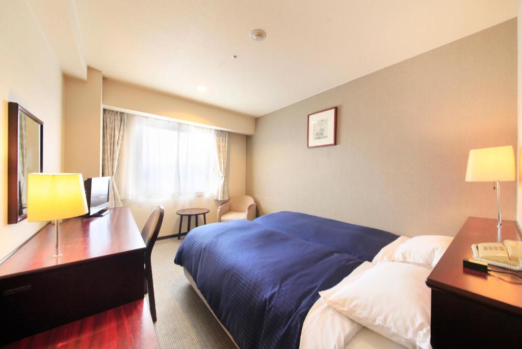 Postel nebo postele na pokoji v ubytování Quintessa Hotel Ogaki