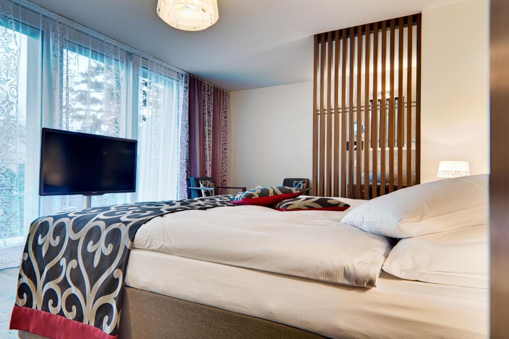 Postel nebo postele na pokoji v ubytování Belvédère Strandhotel