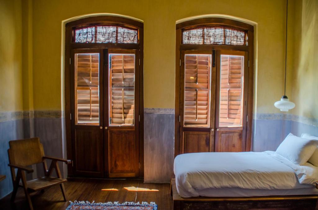 Postel nebo postele na pokoji v ubytování Ren I Tang Heritage Inn