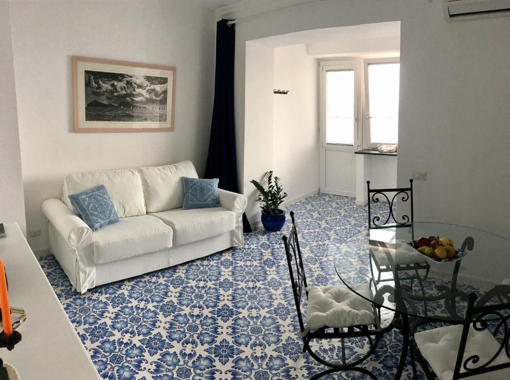 カプリにあるil Porto Capri Casa Vacanzaのリビングルーム(ソファ、テーブル付)