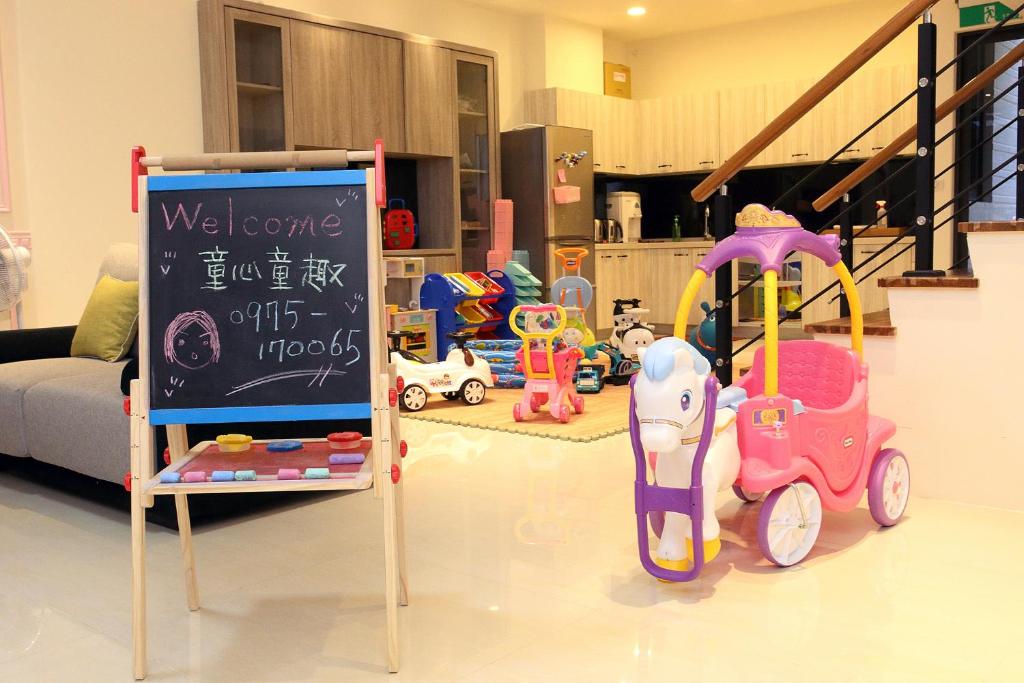a room with a sign and many toys in it at Childlike Innocence Homestay in Ji'an
