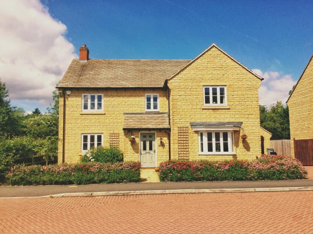 a yellow brick house on a street at Moon House in Oxford