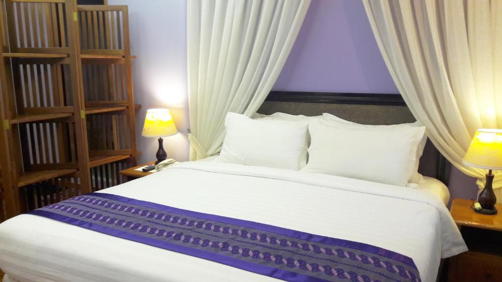 Postel nebo postele na pokoji v ubytování Grand Laurel Hotel