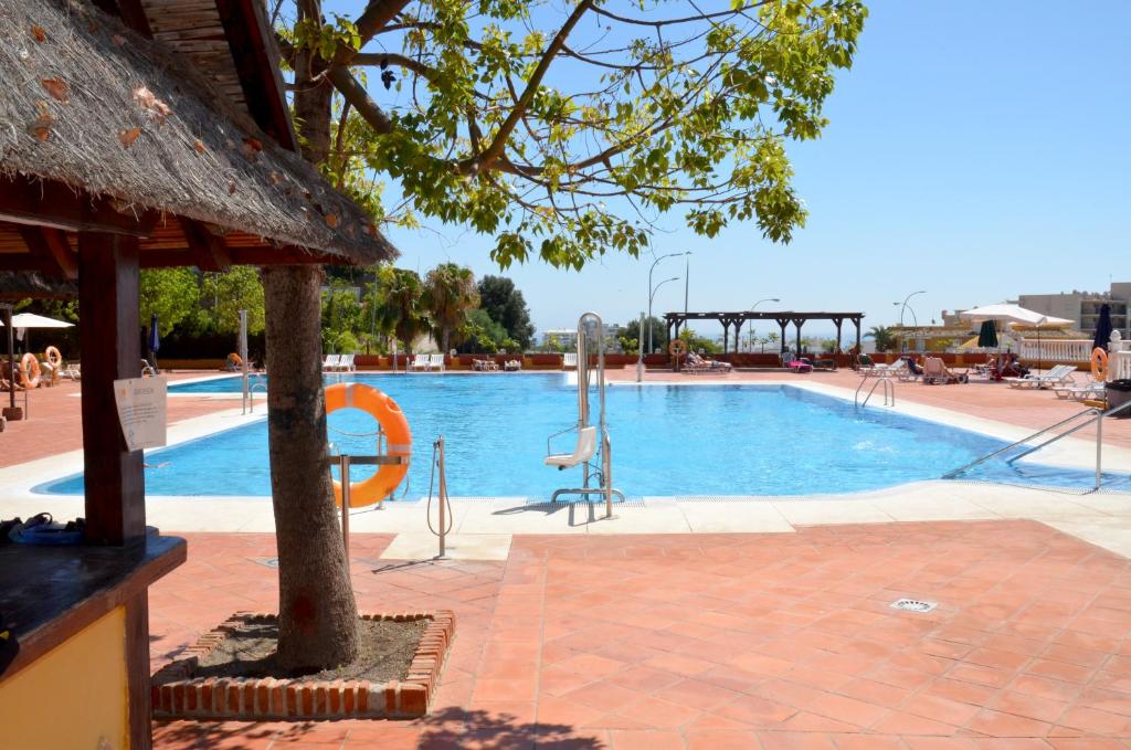 a swimming pool in a resort with a pool at Duquesa de España in Torremolinos