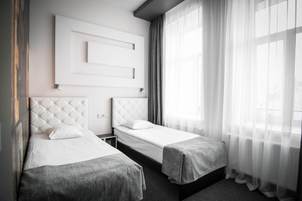 Postel nebo postele na pokoji v ubytování Homelike Hotel
