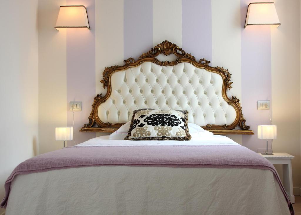 a bedroom with a large bed with a pillow on it at Bagolina Boutique in Parona di Valpolicella