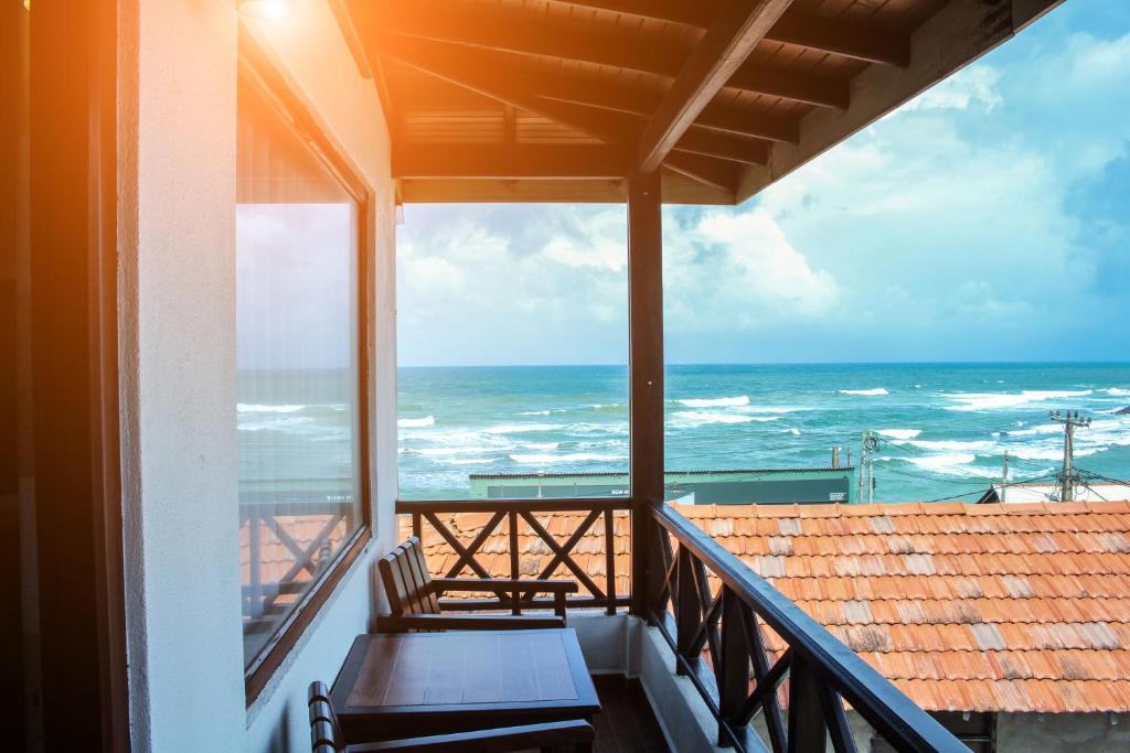 a balcony with a view of the ocean at Cozy Sea view Inn in Hikkaduwa