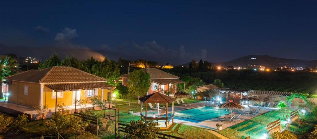 a house with a swimming pool at night at Augoustinos Villa in Zakynthos Town
