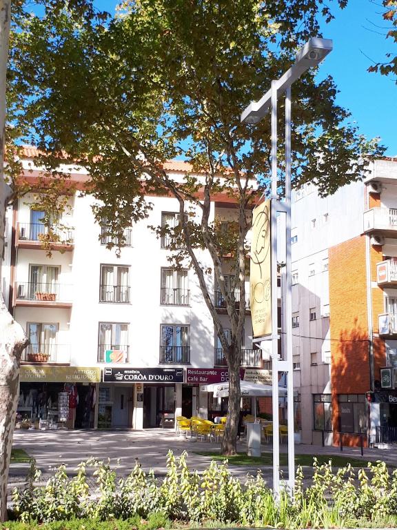 a white building with a street light in front of it at Residencial Coroa D'Ouro in Fátima
