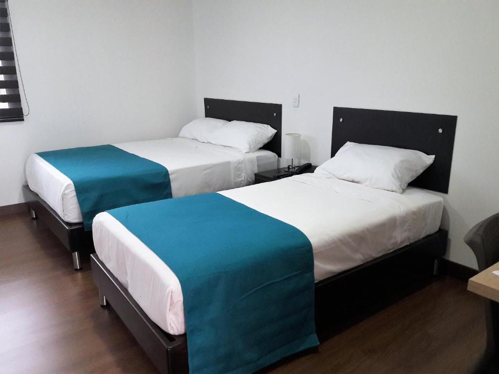 Postel nebo postele na pokoji v ubytování Hotel Valle de San Nicolas