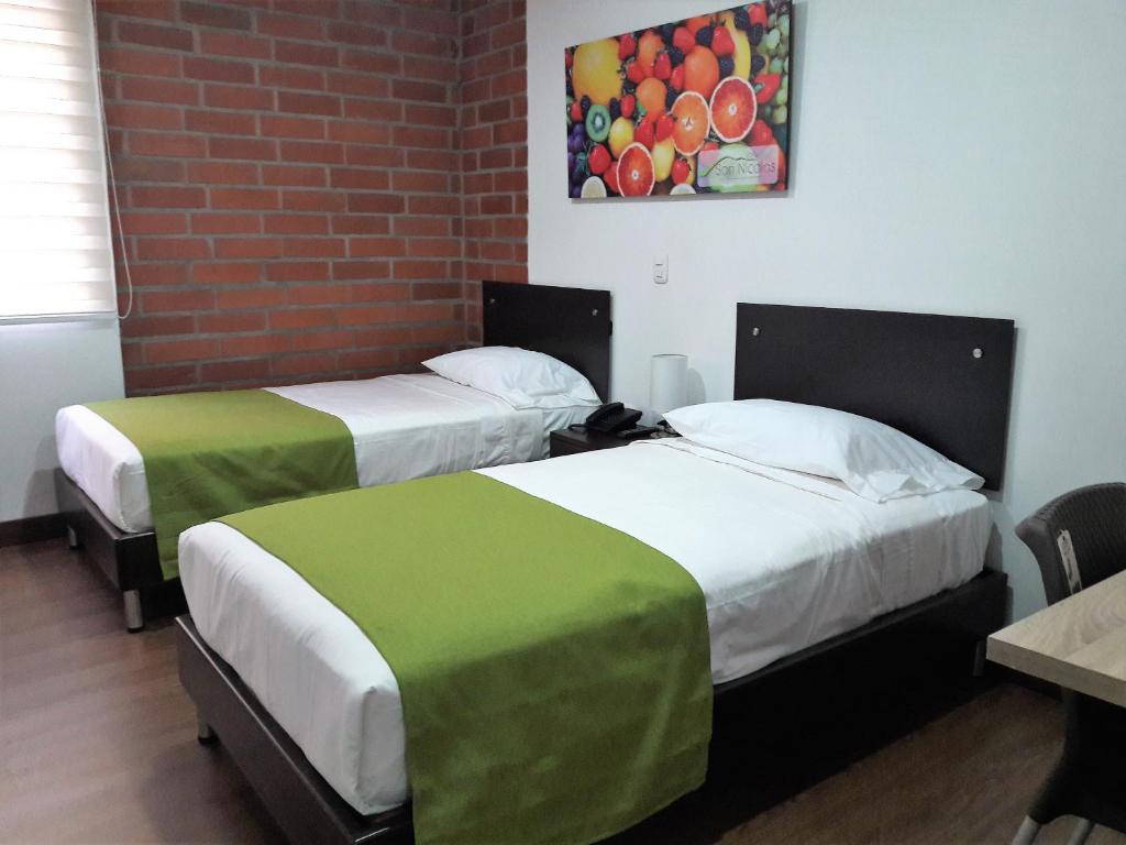 Postel nebo postele na pokoji v ubytování Hotel Valle de San Nicolas