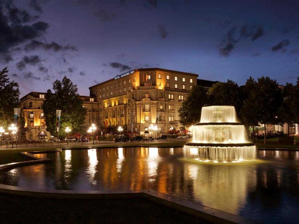 a fountain in front of a building at night at Hotel Nassauer Hof in Wiesbaden