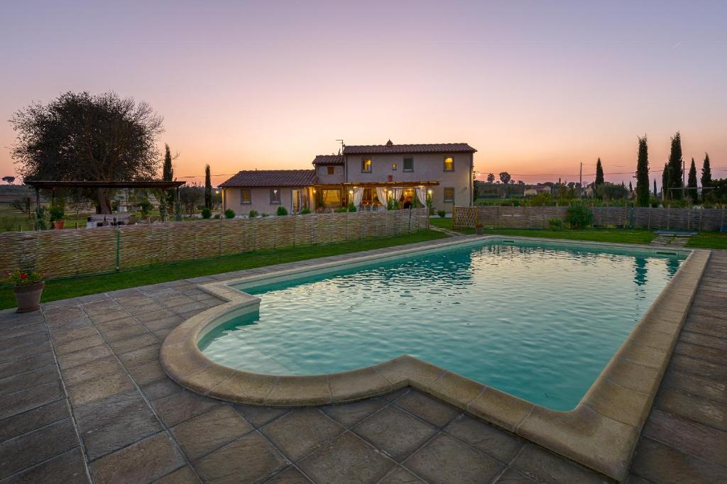 a swimming pool in front of a house at La Rugantina in Cortona
