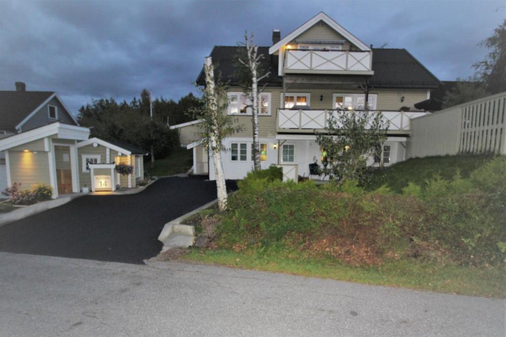 a house on a hill with a driveway at Stokke Apartment in Stokke