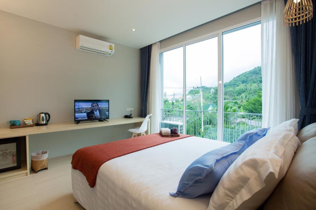Postel nebo postele na pokoji v ubytování LaRio Hotel Krabi-SHA Extra Plus
