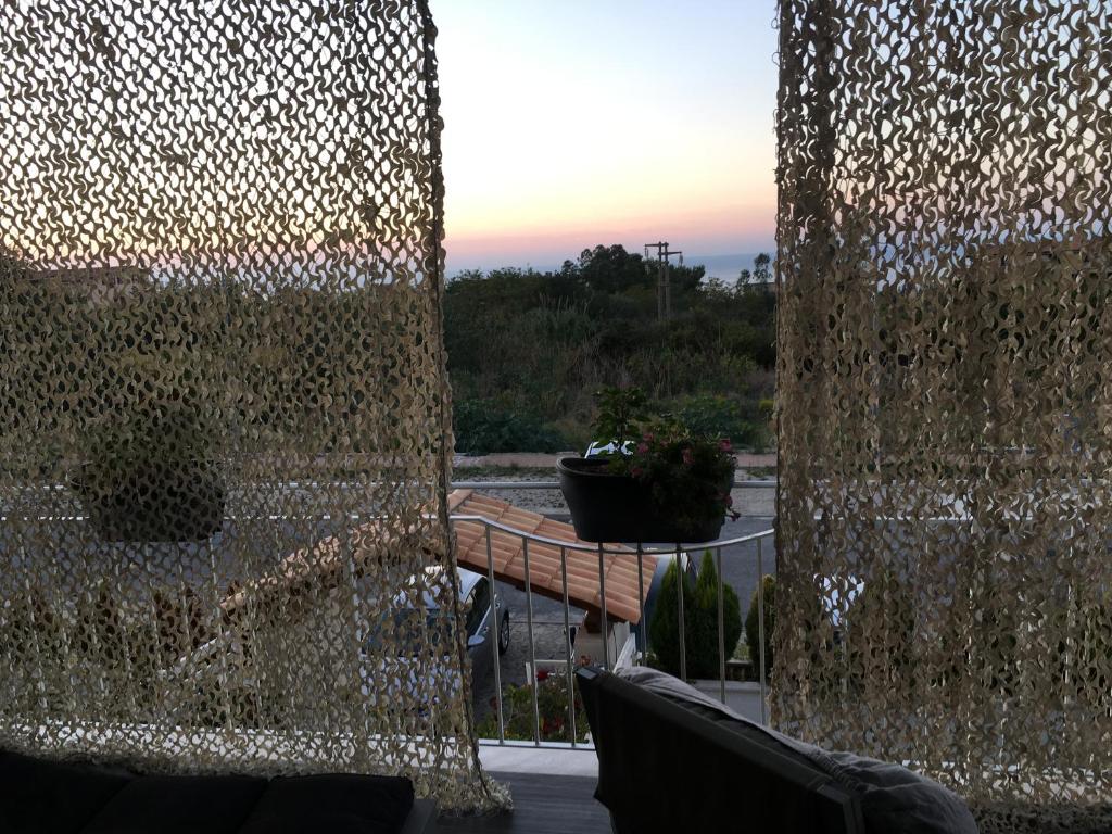 a view of a patio with a wall of glass at Residenza RoMa in Tropea