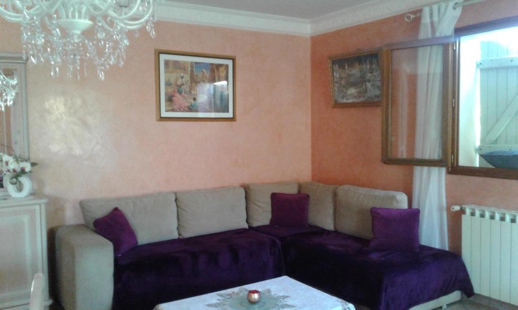 a living room with a couch and a table at Villa seynoise in La Seyne-sur-Mer