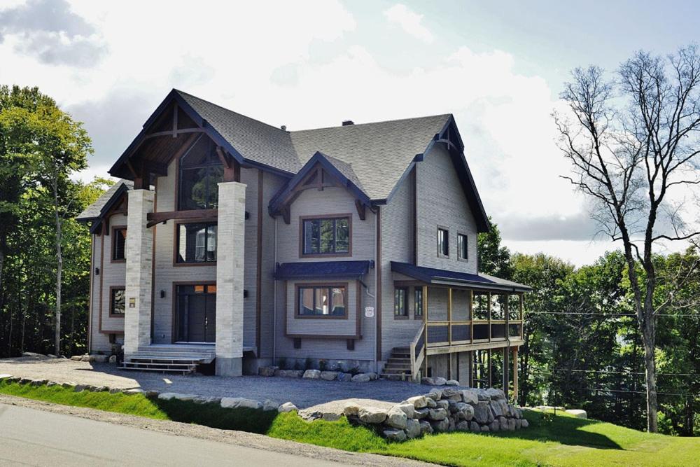 a large house is shown on the side of the road at The Big Jack Chalet 33 Chemin Blanc by Les Chalets Alpins in Stoneham