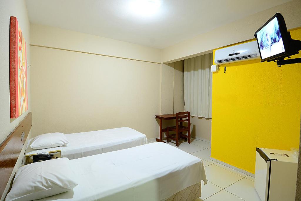 a hospital room with two beds and a tv at Hotel Imperial in Mossoró